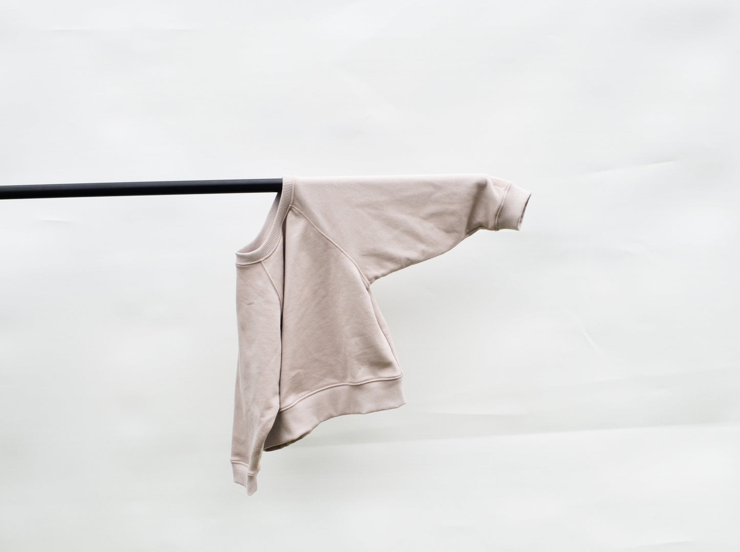 Smokey batwing jumper hanging over pole