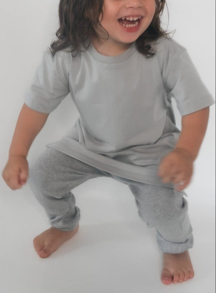 Boy wearing Grey t-shirt and grey loose leggings