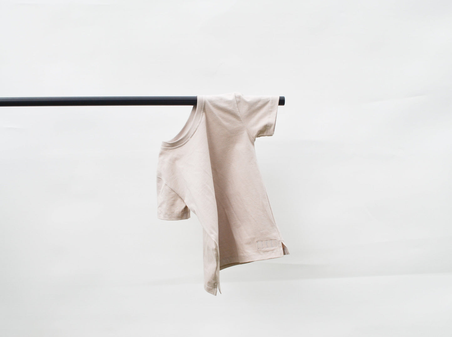 Smokey colour t- shirt hanging over pole