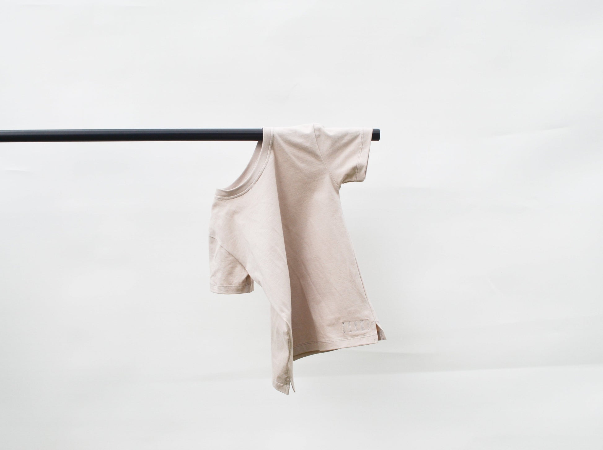 Smokey colour t- shirt hanging over pole