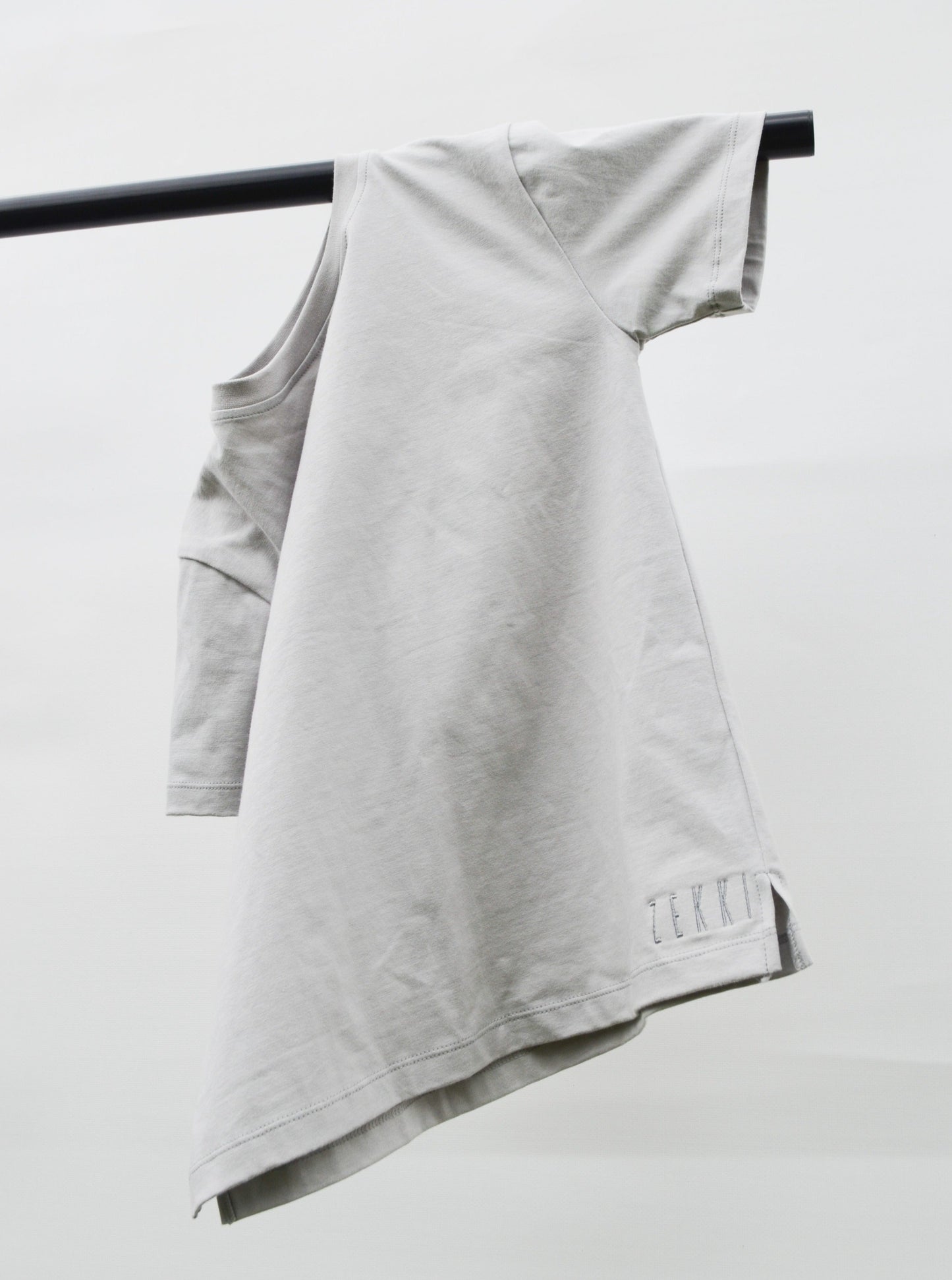 grey colour t-shirt hanging over pole