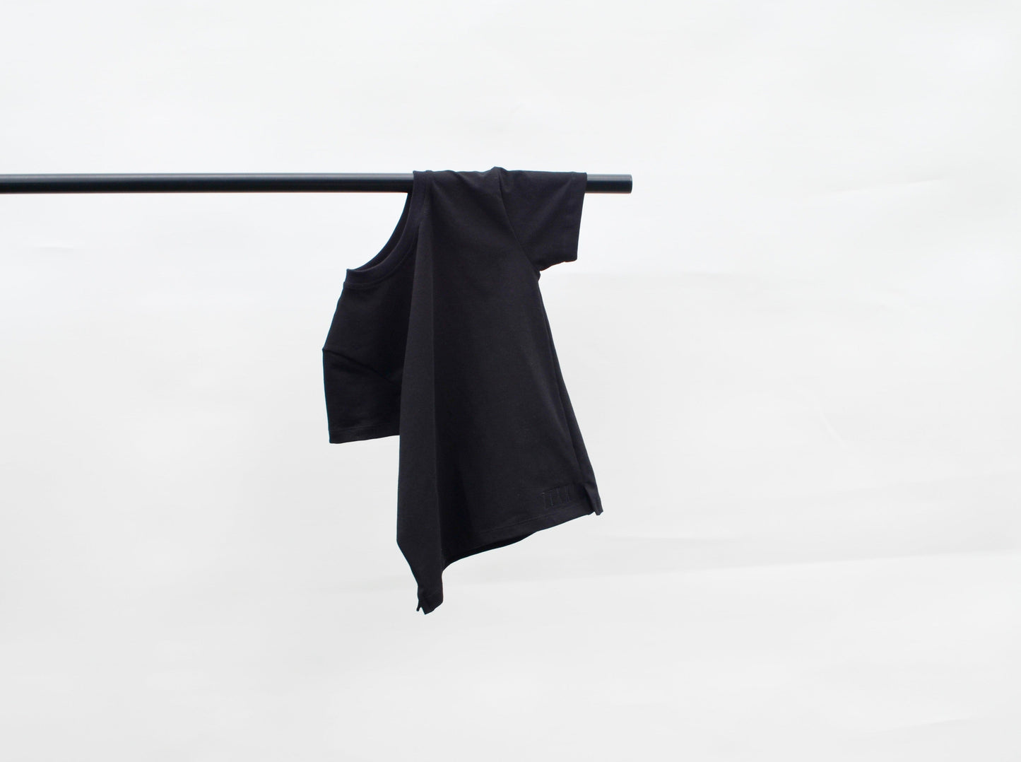Black colour t- shirt hanging over pole