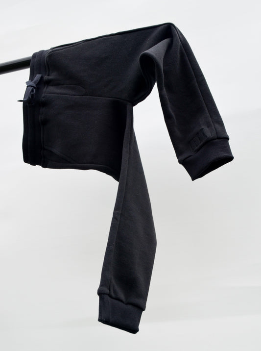 Black colour track pants hanging over bar