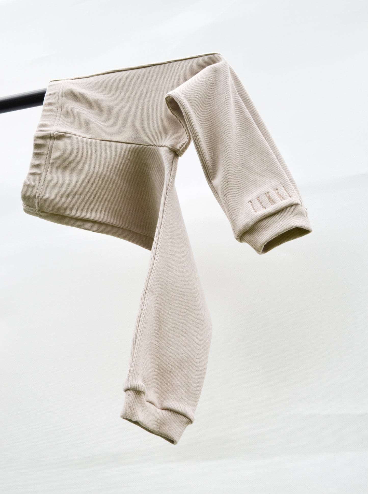 Smokey casual pants hanging over pole