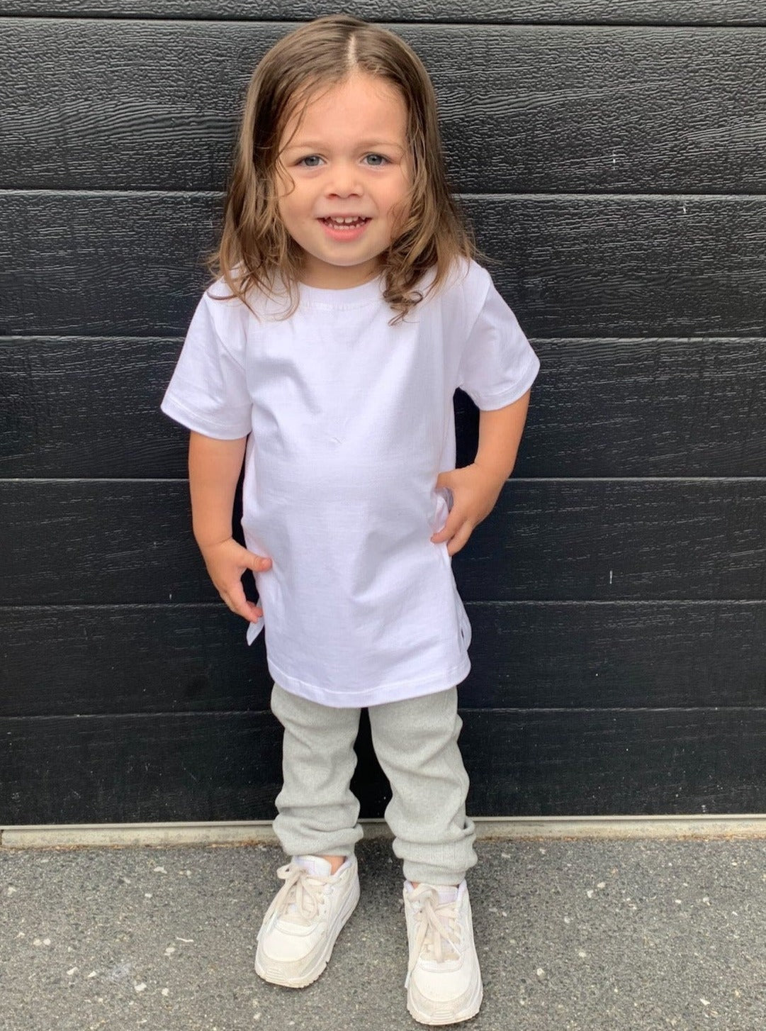 Boy wearing white longline t-shirt and grey legging